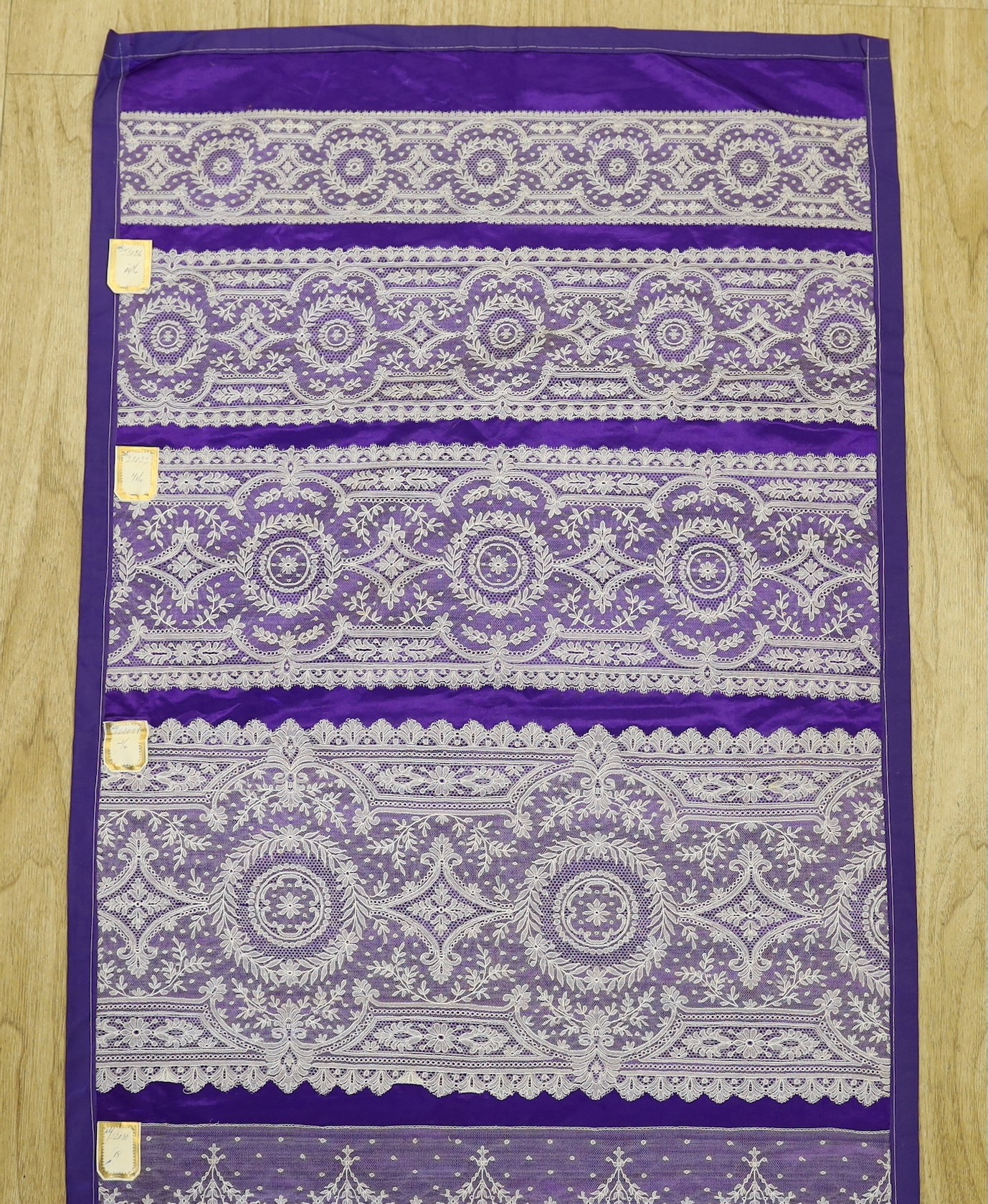 A late 19th, early 20th century retail sample display of various lace designs